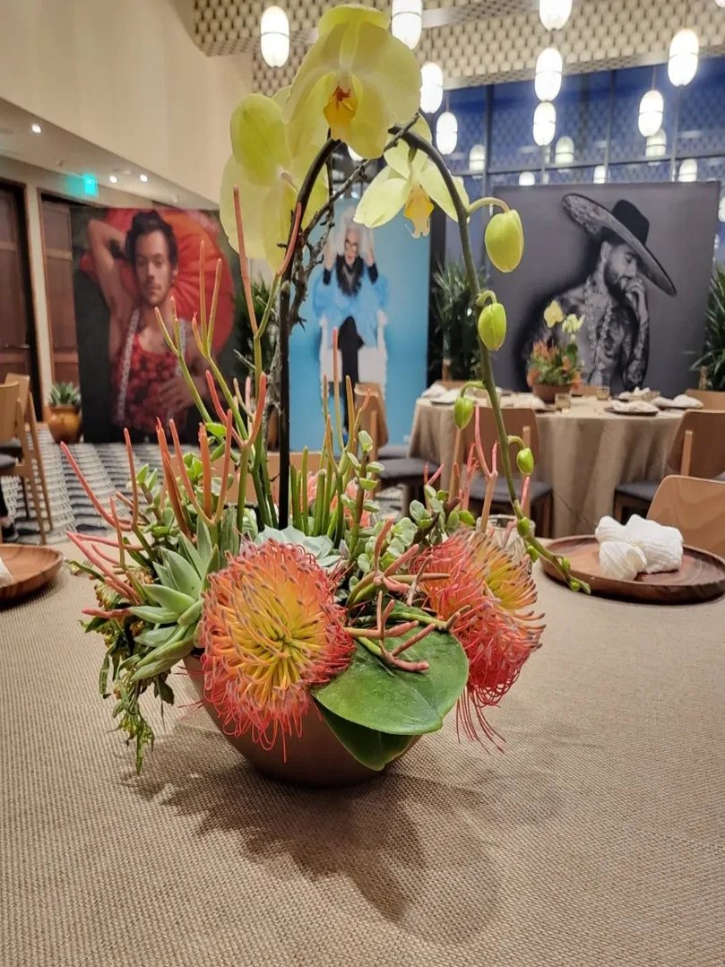Pincushion protea, orchid, and succulent statement piece at a corporate event